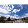 asphalt road in beautiful countryside on sunny summer day
