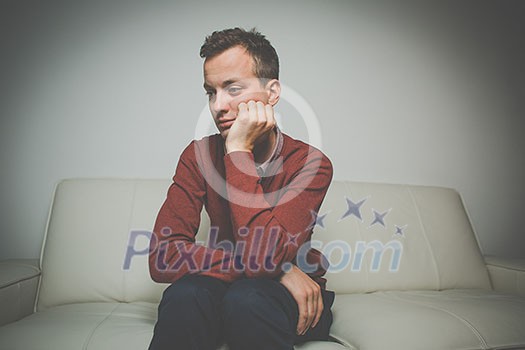 Depressed young man going through a rough patch in his life - suffering from mental exhaustion/anxiety/burnout/depression (color toned image) Depressed young man going through a rough patch in his life - suffering from mental exhaustion/anxiety/burnout/depression (color toned image)