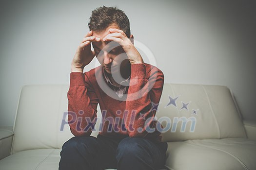 Depressed young man going through a rough patch in his life - suffering from mental exhaustion/anxiety/burnout/depression (color toned image) Depressed young man going through a rough patch in his life - suffering from mental exhaustion/anxiety/burnout/depression (color toned image)