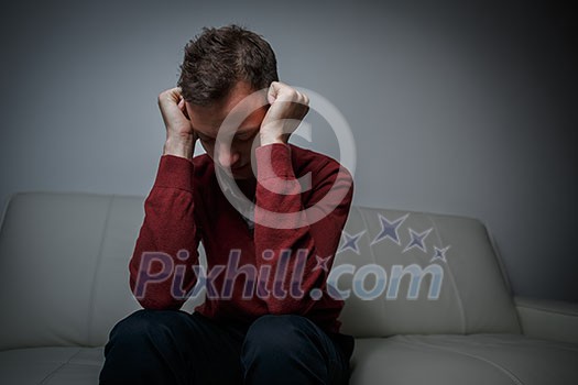 Depressed young man going through a rough patch in his life - suffering from mental exhaustion/anxiety/burnout/depression (color toned image) Depressed young man going through a rough patch in his life - suffering from mental exhaustion/anxiety/burnout/depression (color toned image)