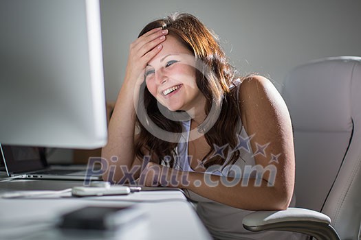 Woman working on a computer in a home office Woman working on a computer in a home office