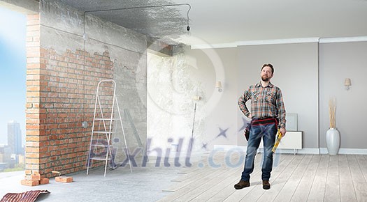 Builder man in checked shirt with tool belt on waist Builder man in checked shirt with tool belt on waist