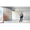 Builder man in checked shirt with tool belt on waist