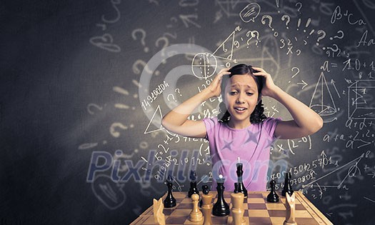 Young caucasian kid girl playing game of chess Young caucasian kid girl playing game of chess