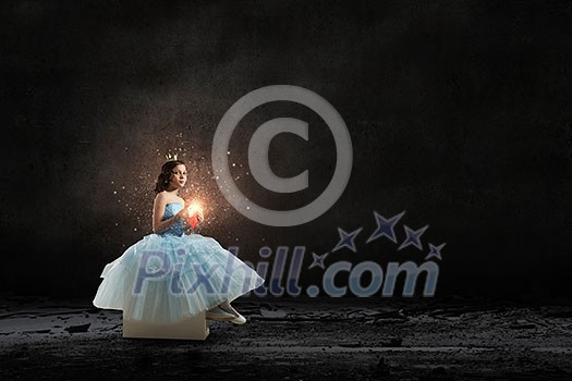 Little girl princess in blue dress with diadem on head and red heart in hands Little girl princess in blue dress with diadem on head and red heart in hands