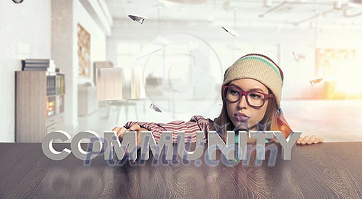 Attractive student girl in red glasses peeping from under table Attractive student girl in red glasses peeping from under table