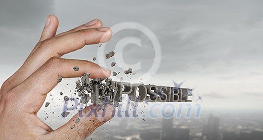 Close view of male hand taking with fingers word impossible Close view of male hand taking with fingers word impossible