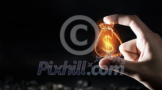 Tiny dollar currency sign holden between fingers Tiny dollar currency sign holden between fingers