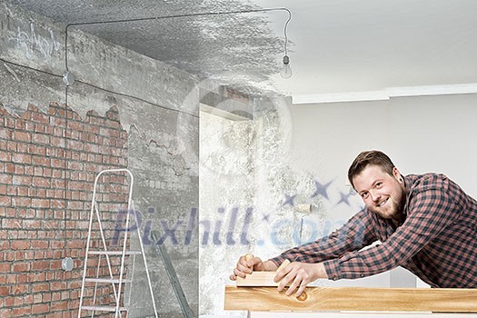 Young man in checked shirt with plane in room