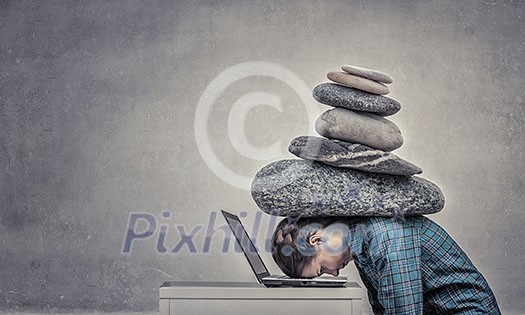 Woman programmer pressed with heavy stone to laptop Woman programmer pressed with heavy stone to laptop