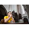 Handsome young man praying in a church