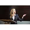 Pretty, young business woman giving a presentation in a conference/meeting setting (shallow DOF; color toned image)
