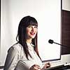 Pretty, young business woman giving a presentation in a conference/meeting setting (shallow DOF; color toned image)