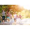 summer joy group of happy friends having  fun while running and splashing on river