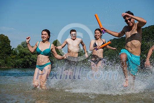 summer joy group of happy friends having fun while running and splashing on river summer joy group of happy friends having fun while running and splashing on river