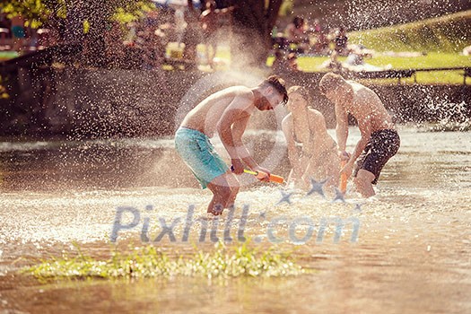 summer joy group of happy friends having fun while running and splashing on river summer joy group of happy friends having fun while running and splashing on river