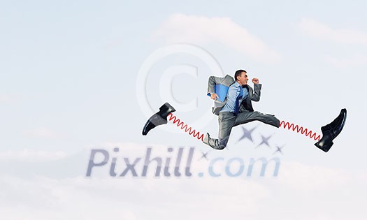 Businessman in suit running with big springs on feet Businessman in suit running with big springs on feet
