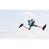 Businessman in suit running with big springs on feet