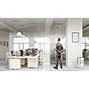 Thoughtful businessman standing with back in empty office