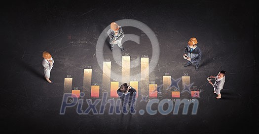 Top view of business people and graphs and diagrams on floor Top view of business people and graphs and diagrams on floor