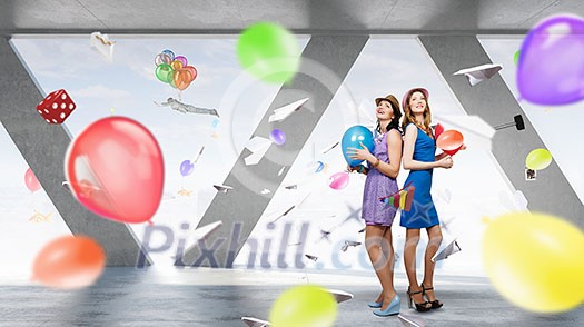 Two young woman in casual celebrating in office Two young woman in casual celebrating in office