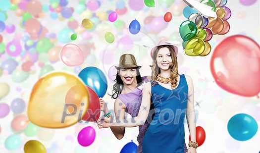 Two young woman in casual with colorful balloons celebrating Two young woman in casual with colorful balloons celebrating