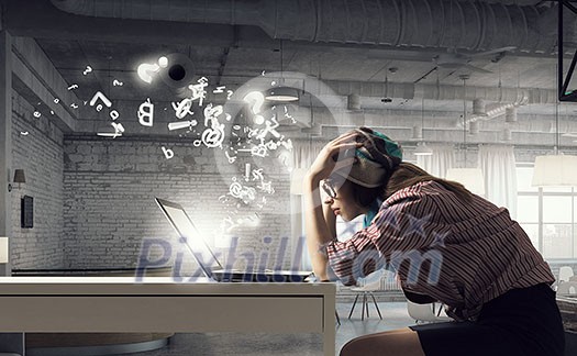 Young hipster girl sitting at table and working on laptop Young hipster girl sitting at table and working on laptop