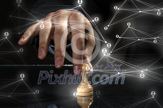 Close up of man hand making chess move on dark background Close up of man hand making chess move on dark background
