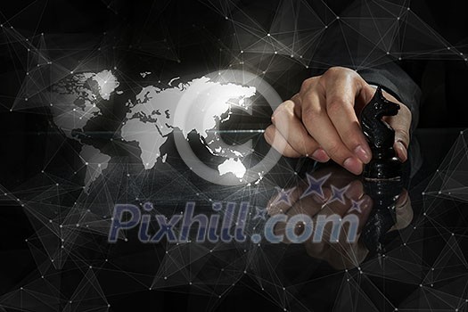 Close up of man hand making chess move on dark background Close up of man hand making chess move on dark background