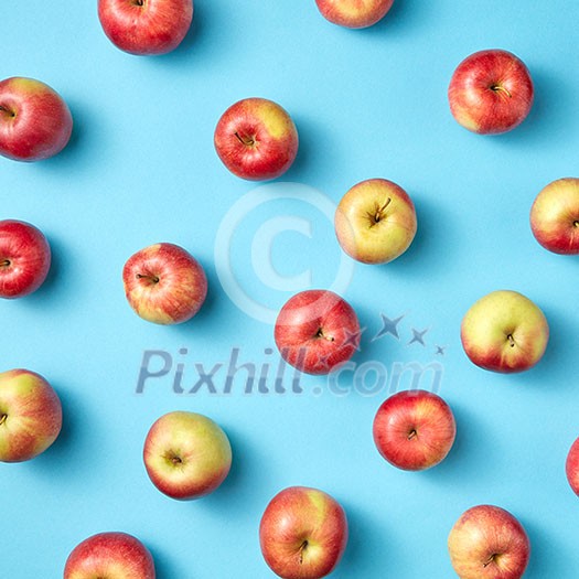 Fresh organic preshly picked apples as pattern on a blue background. Flat lay. Vegetarian eating concept. Fresh organic preshly picked apples as pattern on a blue background. Flat lay. Vegetarian eating concept.