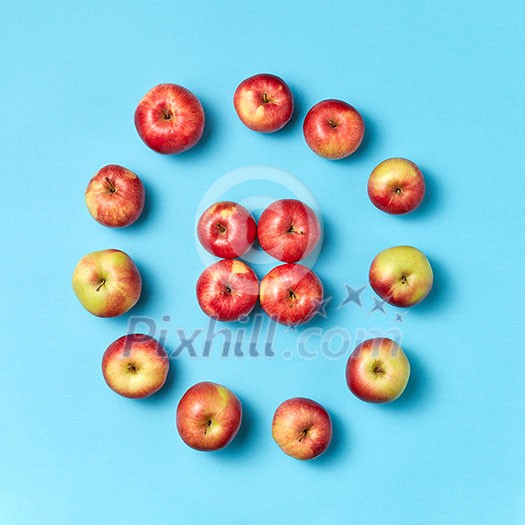 Fresh natural vegan apples pattern on a blue background with copy space. Concept of organic eating. Top view. Fresh natural vegan apples pattern on a blue background with copy space. Concept of organic eating. Top view.