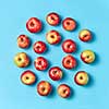 Freshly picked juicy apples round frame on a blue background with copy space. Concept of healthy eating. Flat lay.