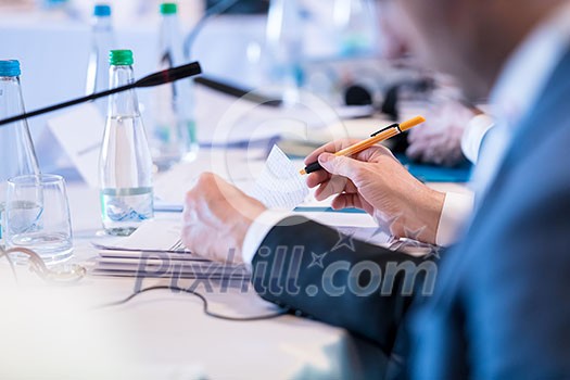 closeup shot of business people hands using pen while taking notes on education training during business seminar at modern conference room closeup shot of business people hands using pen while taking notes on education training during business seminar at modern conference room