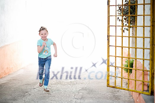 happy cute little girl enjoying running through the streets of the city happy cute little girl enjoying running through the streets of the city