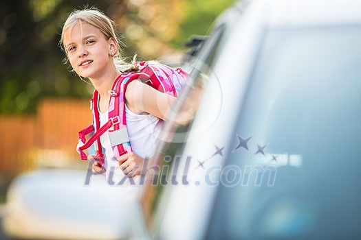 Cute little girl going home from school, looking well before crossing the street Cute little girl going home from school, looking well before crossing the street