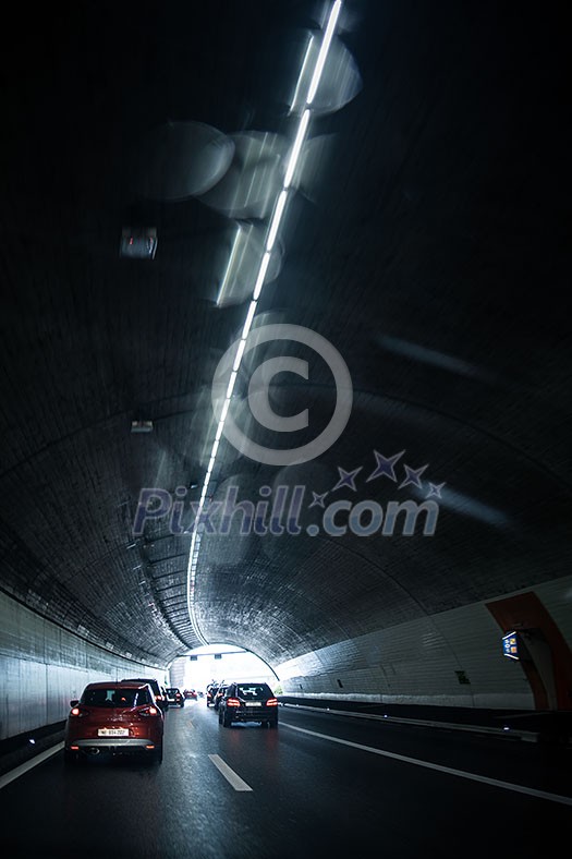Cars on a highway going through a long modern tunnel (motion blurred image; color toned image) Cars on a highway going through a long modern tunnel (motion blurred image; color toned image)