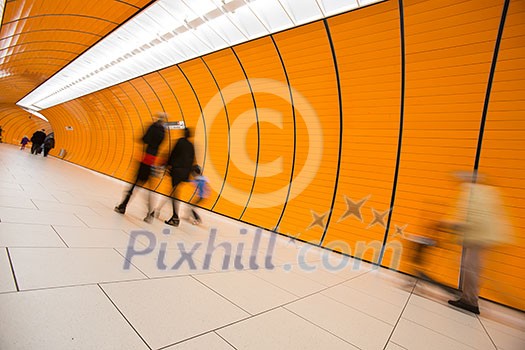 People rushing through a subway corridor (motion blur technique is used to convey movement) People rushing through a subway corridor (motion blur technique is used to convey movement)