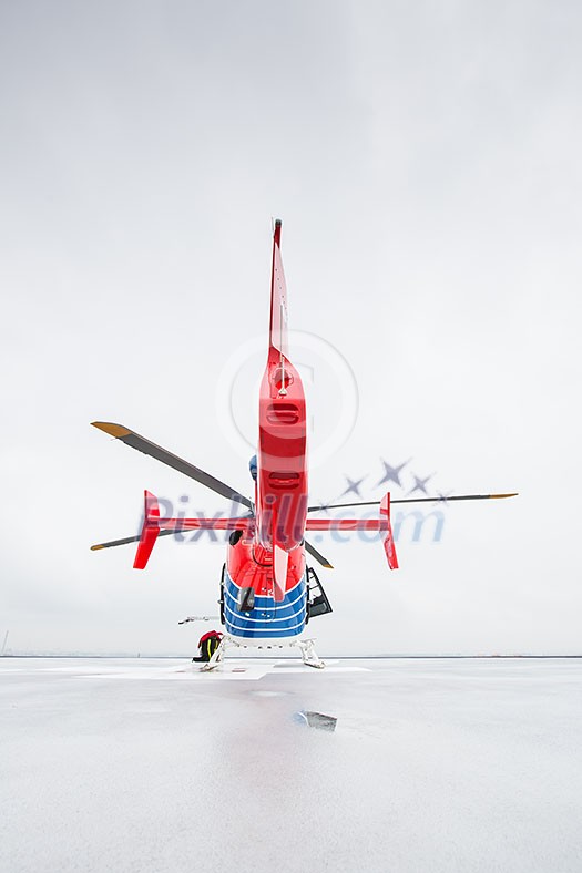 Modern medical helicopter on a hospital rooftop helipad from behind - shallow DOF Modern medical helicopter on a hospital rooftop helipad from behind - shallow DOF