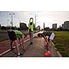 multiethnic group of young people on the jogging beautiful morning as the sun rises in the streets of the city