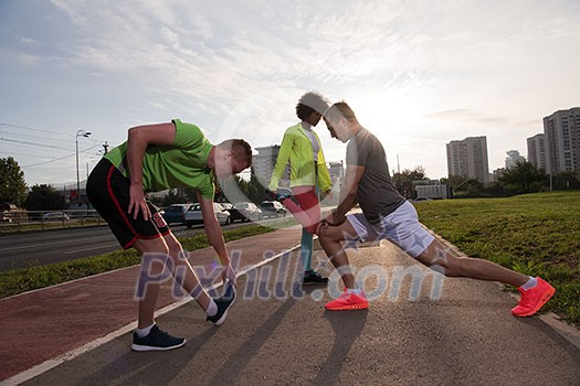 multiethnic group of young people on the jogging beautiful morning as the sun rises in the streets of the city multiethnic group of young people on the jogging beautiful morning as the sun rises in the streets of the city