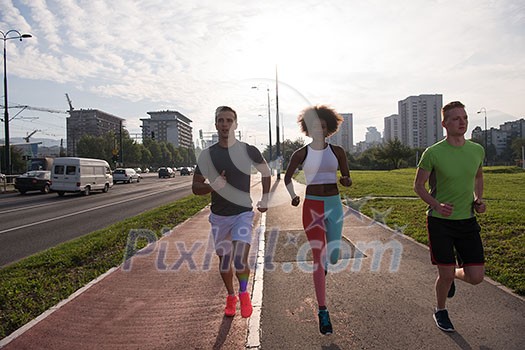 multiethnic group of young people on the jogging beautiful morning as the sun rises in the streets of the city multiethnic group of young people on the jogging beautiful morning as the sun rises in the streets of the city