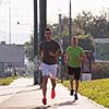 athletic young men enjoy running while the sun rises over the city