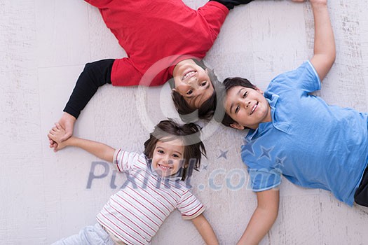 happy young boys having fun on the floor in a new modern home happy young boys having fun on the floor in a new modern home