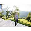 portrait of a young handsome successful man in front of his luxury home villa