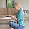 beautiful young women using laptop computer on the floor of her luxury home