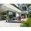 young handsome man doing morning yoga exercises in front of his luxury home villa