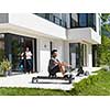 young handsome man doing morning exercises in front of his luxury home villa