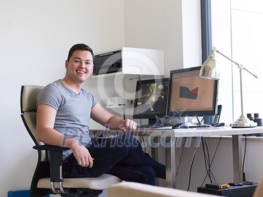 portrait of security system operator looking at CCTV footage at desk in office portrait of security system operator looking at CCTV footage at desk in office
