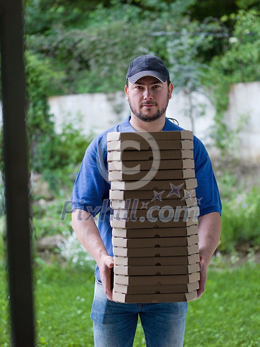 pizza delivery portrait of a young deliverers with lots of stacked boxes of pizza in hands pizza delivery portrait of a young deliverers with lots of stacked boxes of pizza in hands