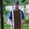 pizza delivery  portrait of a young deliverers with lots of stacked boxes of pizza in hands